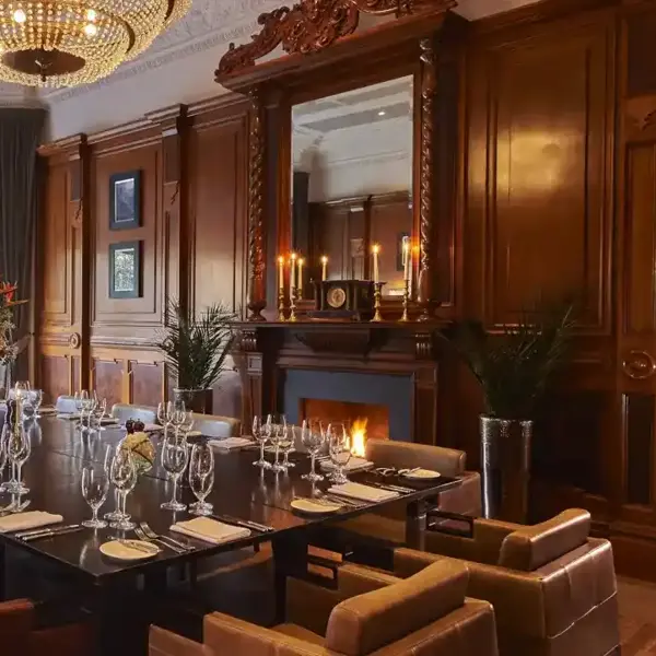 A wooden table adorned with glasses and neatly arranged place settings.