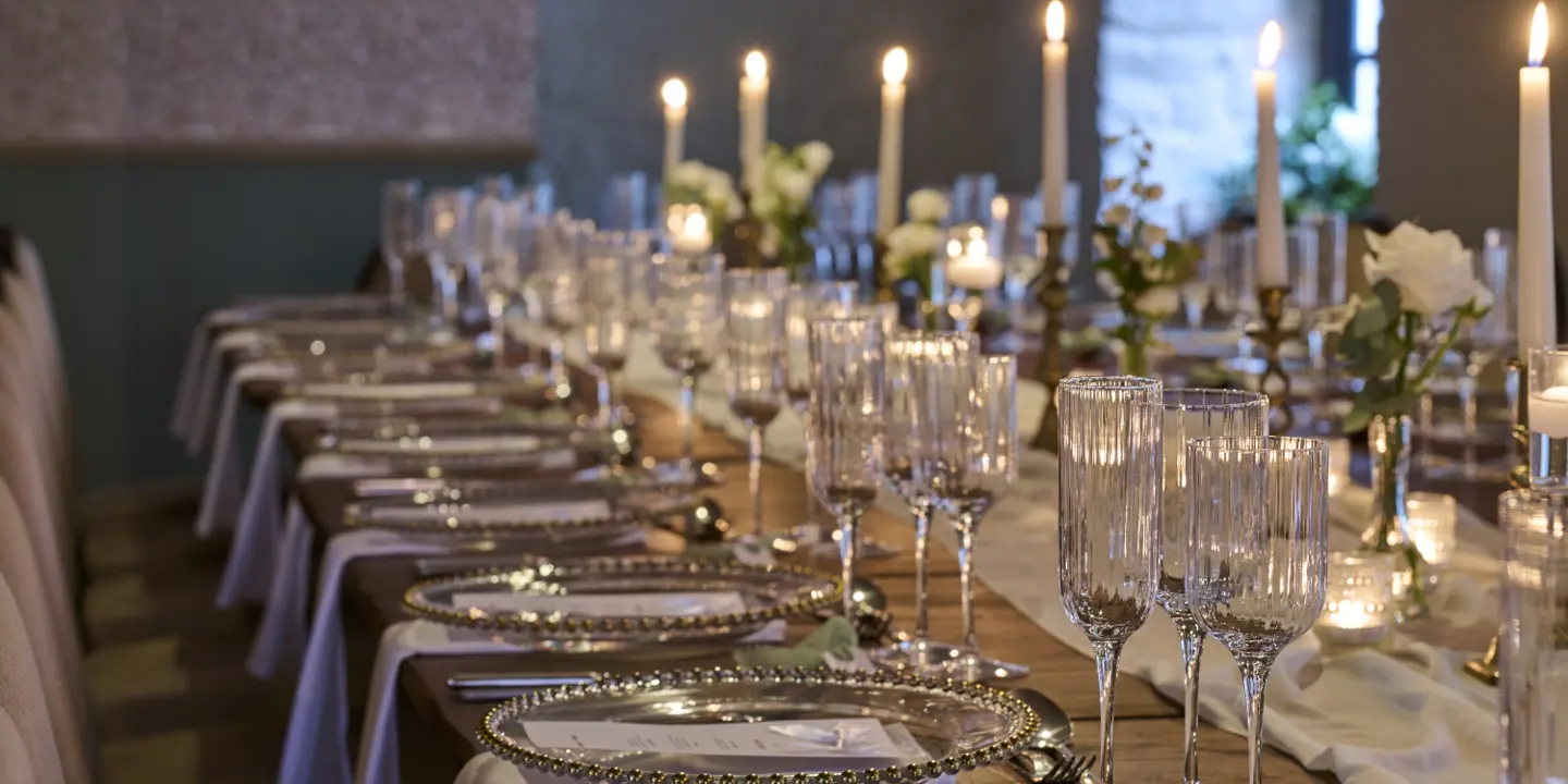 An elegantly decorated room with neatly arranged white chairs adorned with bows.