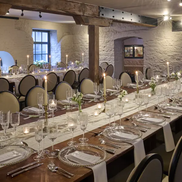 A room adorned with numerous white chairs elegantly decorated with bows.