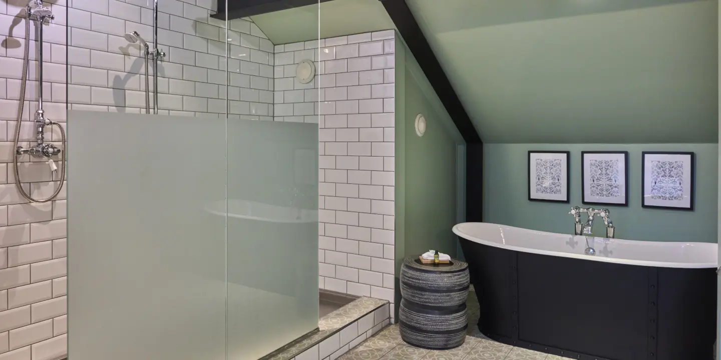 A bathroom featuring a bathtub, sink, and mirror.