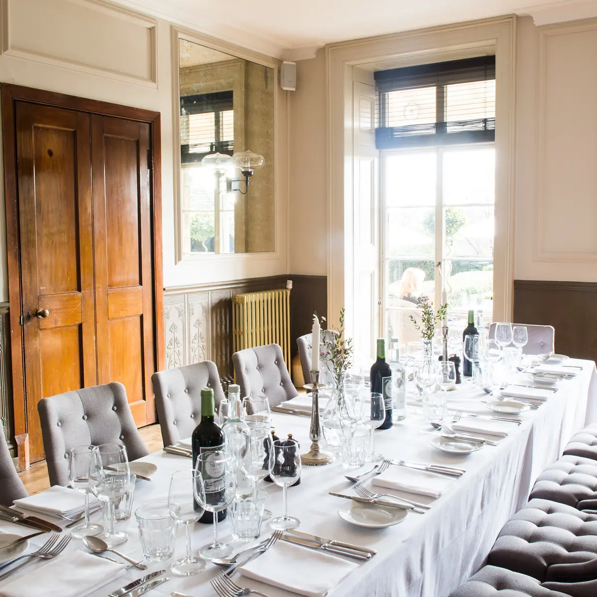 A beautifully arranged table adorned with elegant wine glasses and bottles of fine wine.