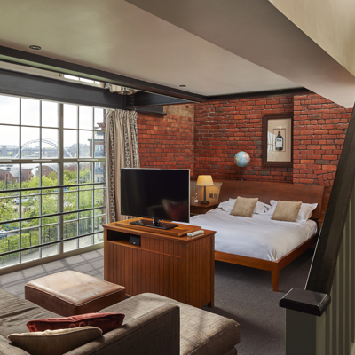 Bedroom featuring a comfortable bed and television.