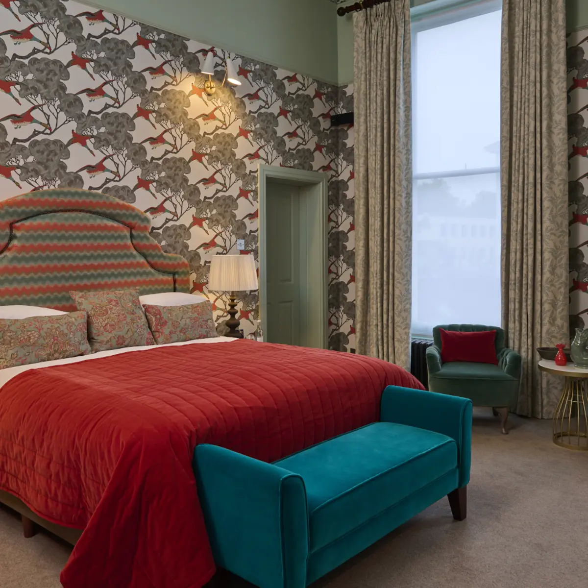 A bedroom decorated with blue and red furniture 