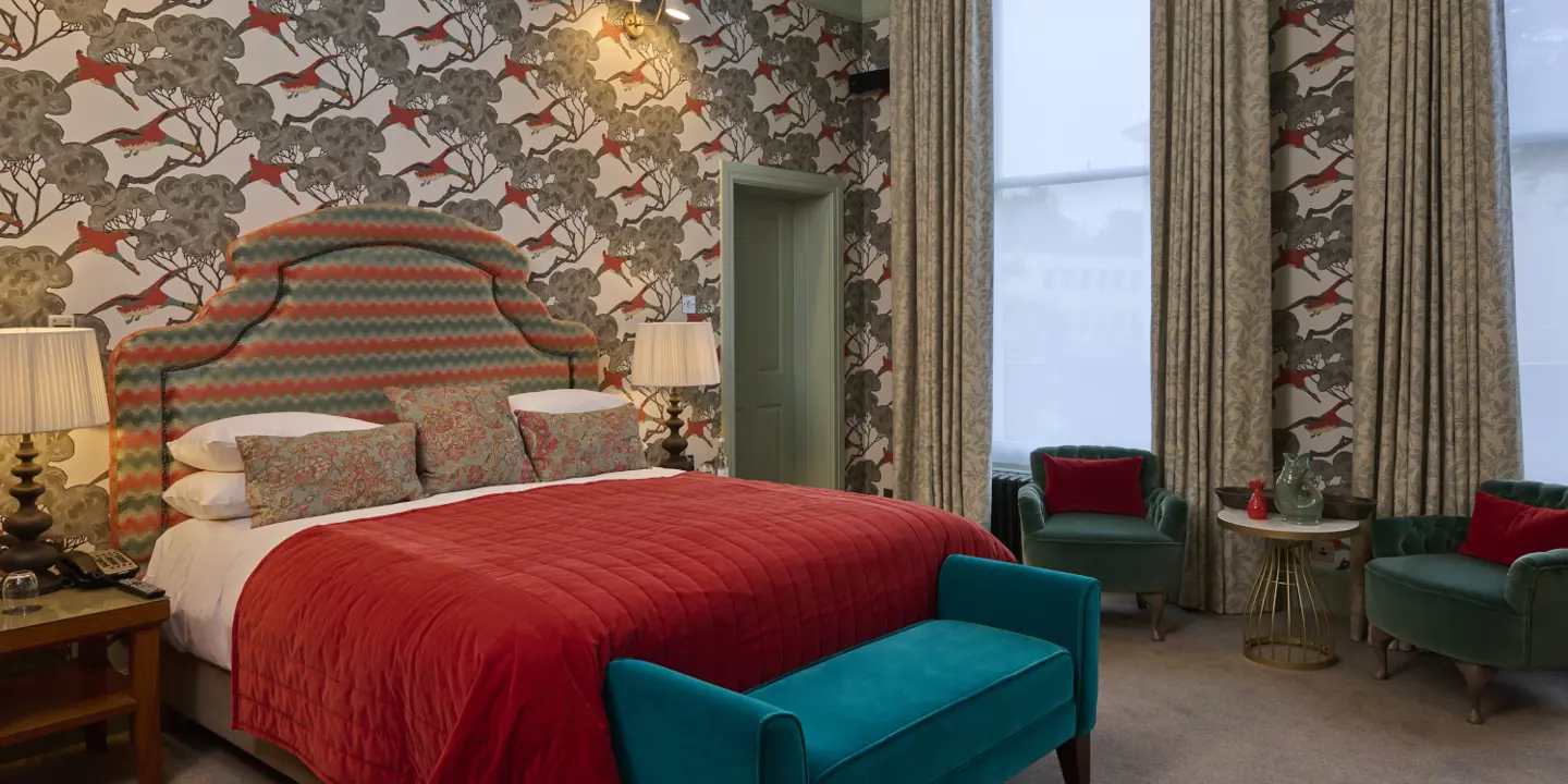 A bedroom decorated with blue and red furniture