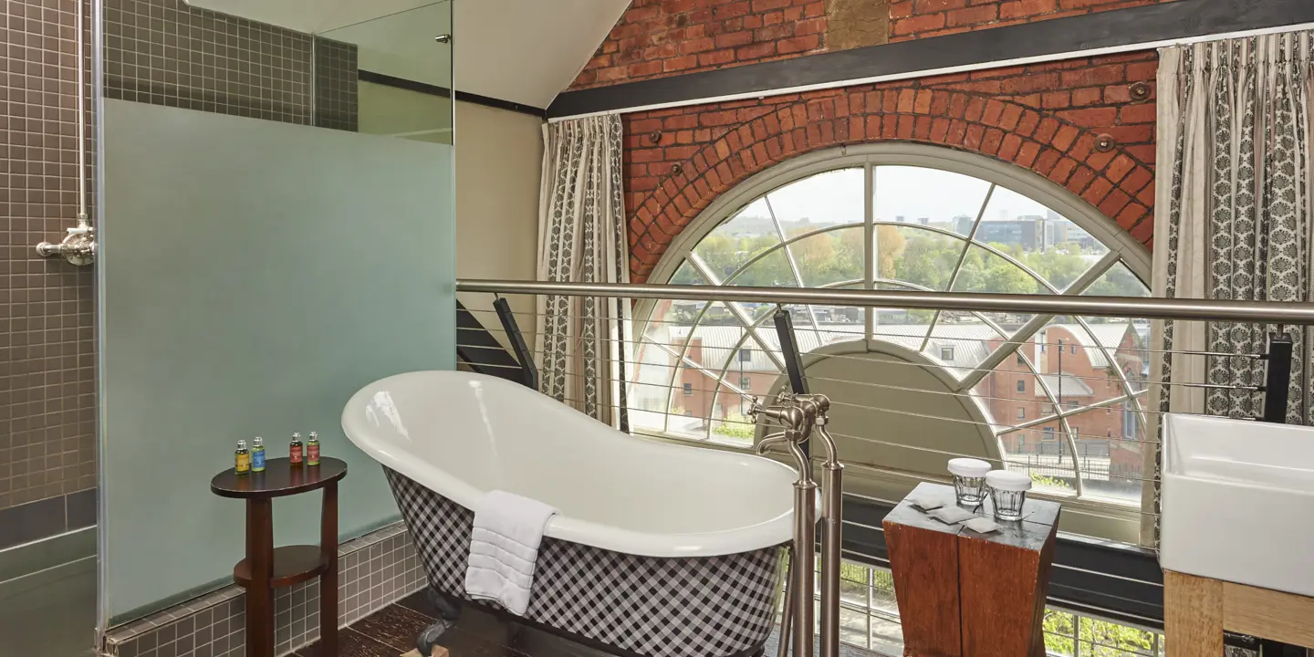 Bathtub and window in a bathroom.