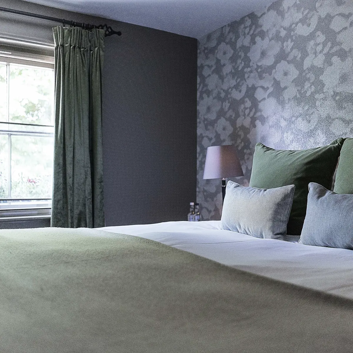 Bedroom featuring a comfortable bed and a window.