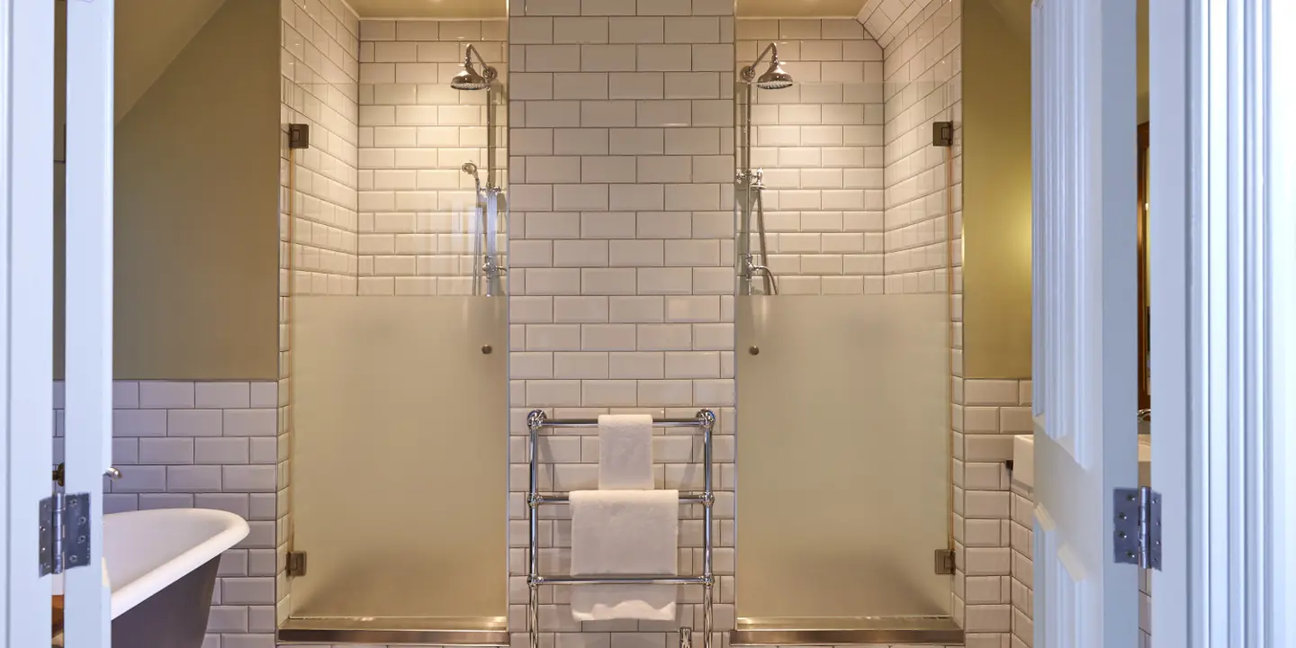 Elegant bathroom with double showers and bathtub