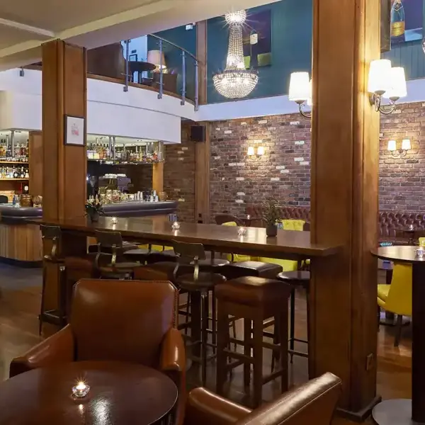 Bar with brown leather chairs and wooden high table and chairs