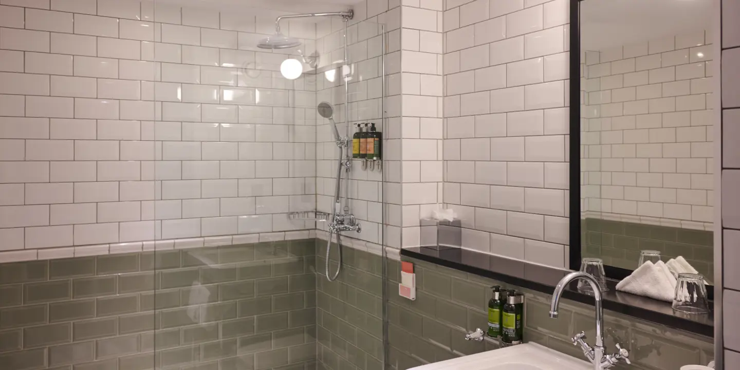 A bathroom featuring a sink, and shower.