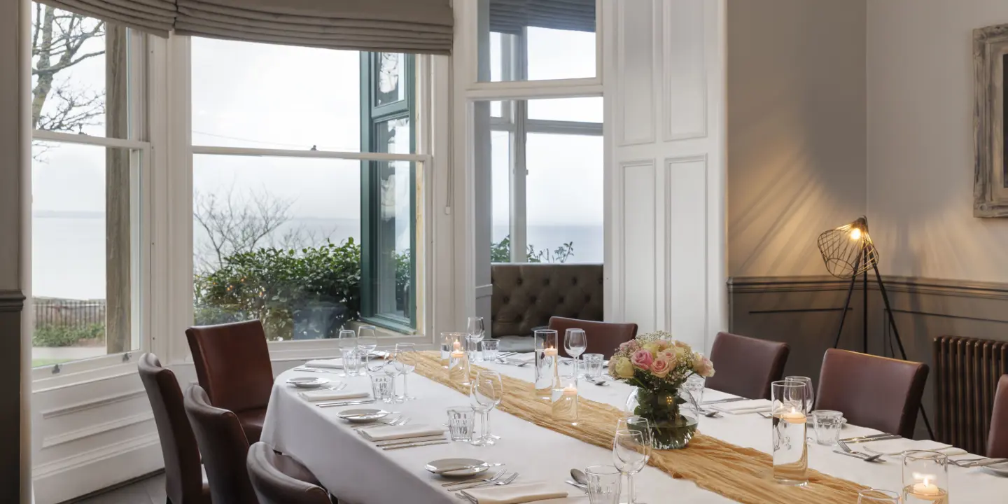 A beautifully arranged table adorned with elegant candles and wine glasses.