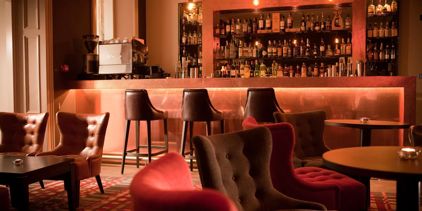 A bustling bar adorned with numerous chairs and tables.