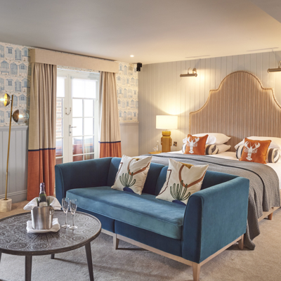 Bedroom featuring a blue couch and bed.