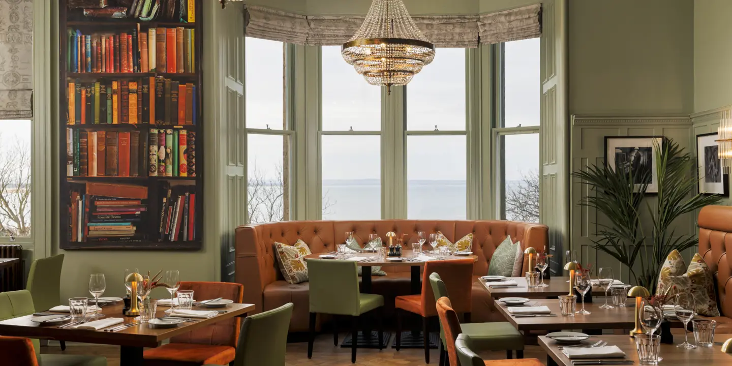 A spacious dining room filled with numerous tables and chairs.