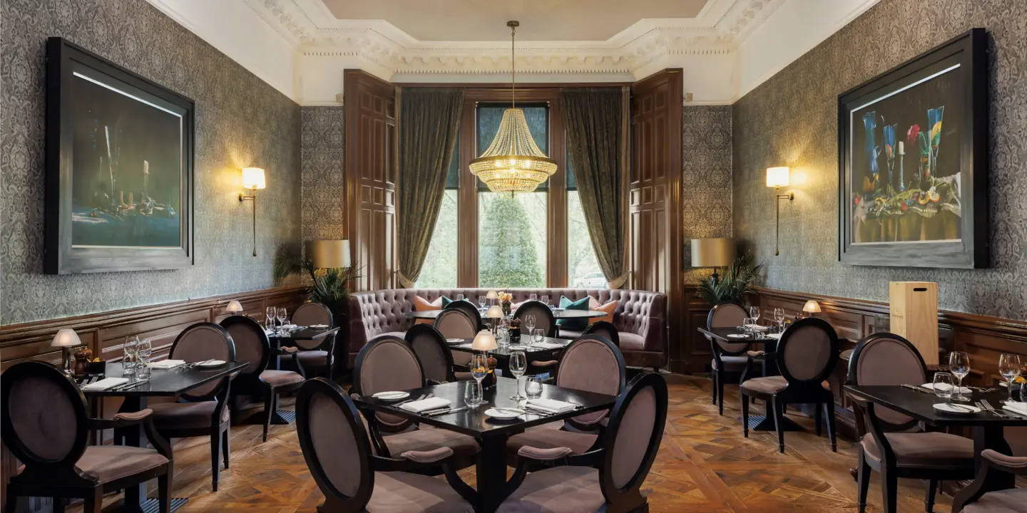 Dining room featuring elegant chairs and a stunning chandelier.